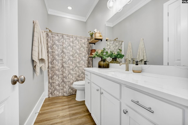 bathroom with toilet, vanity, ornamental molding, and hardwood / wood-style flooring