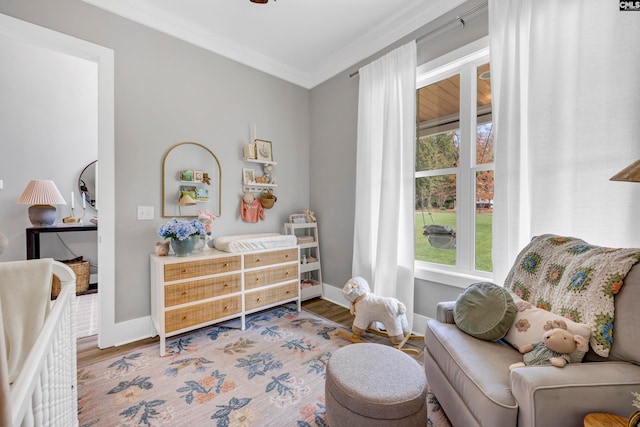 sitting room featuring crown molding, plenty of natural light, and hardwood / wood-style flooring