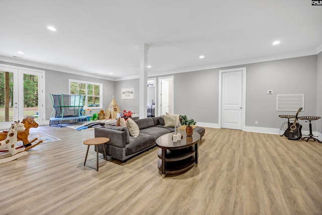 living room featuring french doors, light hardwood / wood-style flooring, and ornamental molding