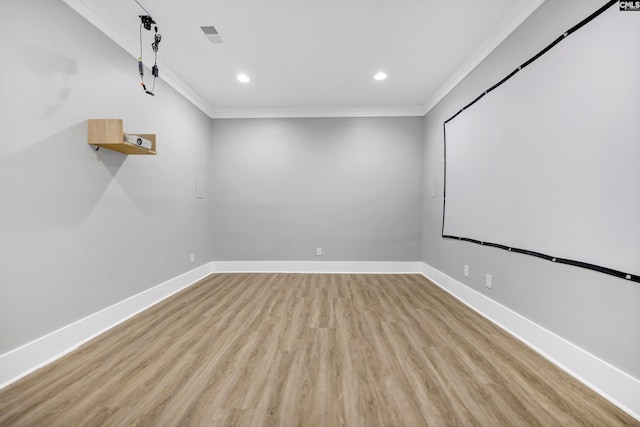 home theater with light hardwood / wood-style floors and ornamental molding