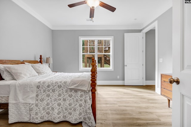 bedroom featuring ceiling fan, light hardwood / wood-style floors, and ornamental molding