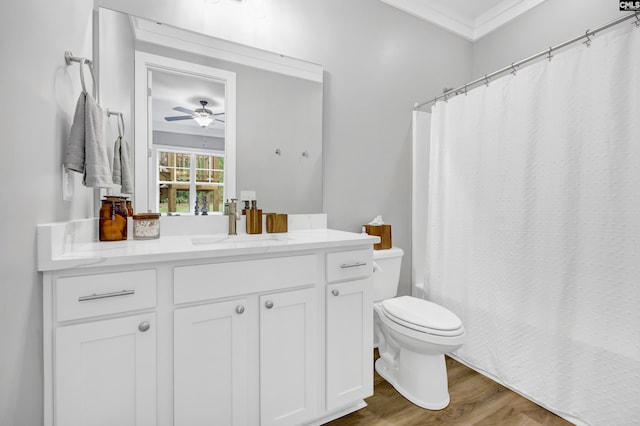 bathroom featuring hardwood / wood-style floors, vanity, ceiling fan, toilet, and ornamental molding