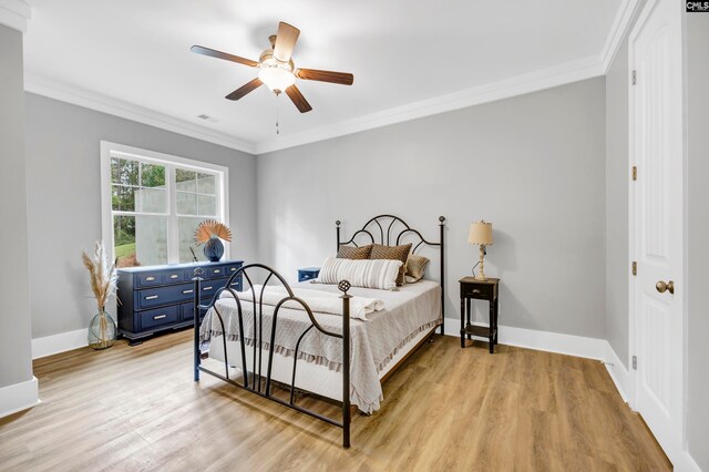 bedroom with ceiling fan, ornamental molding, and light wood-type flooring