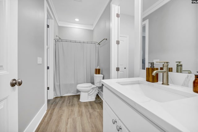 full bathroom featuring shower / bath combo, ornamental molding, vanity, hardwood / wood-style flooring, and toilet