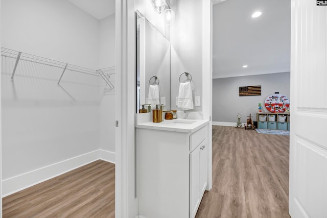 bathroom featuring wood-type flooring and vanity