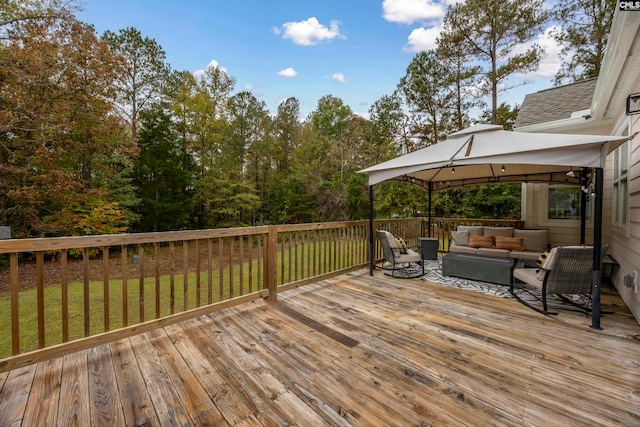 deck with outdoor lounge area, a gazebo, and a yard