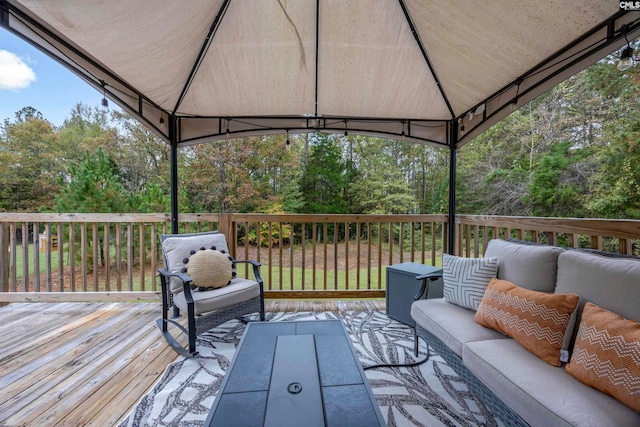 wooden deck with a gazebo and an outdoor hangout area