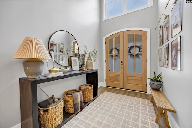 entryway featuring a high ceiling and light wood-type flooring