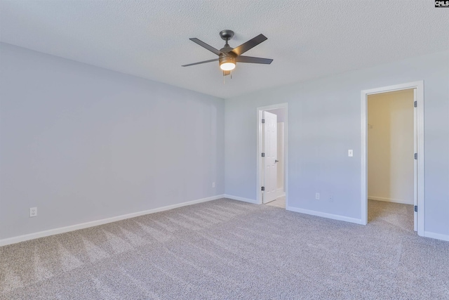 carpeted empty room featuring a textured ceiling and ceiling fan