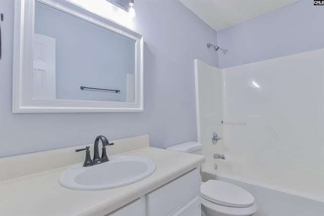 full bathroom featuring a textured ceiling, vanity, toilet, and tub / shower combination