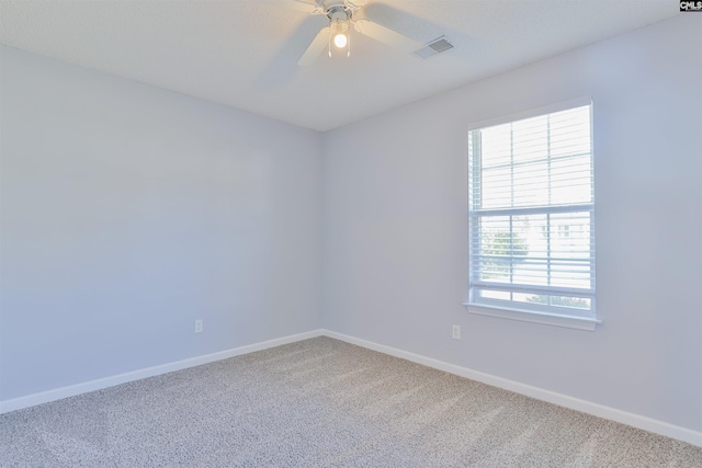 carpeted spare room featuring ceiling fan