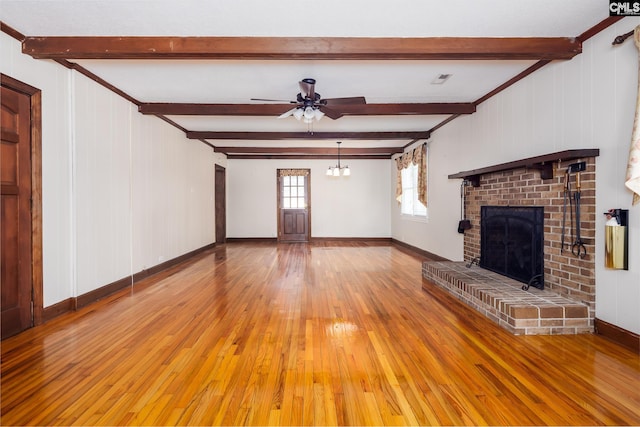 unfurnished living room with beam ceiling, ceiling fan, a fireplace, and light hardwood / wood-style floors