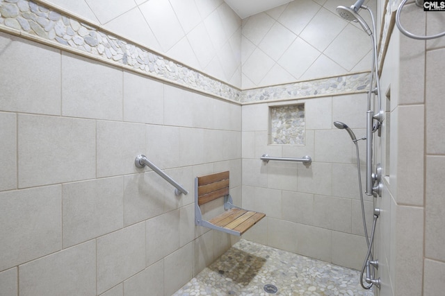 bathroom with a tile shower