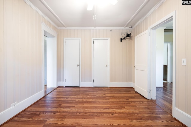 unfurnished bedroom featuring ceiling fan, dark hardwood / wood-style flooring, and ornamental molding