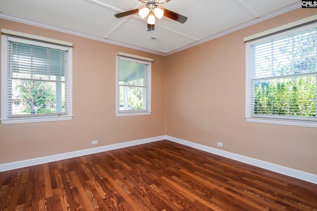 spare room with ceiling fan, a healthy amount of sunlight, crown molding, and dark wood-type flooring