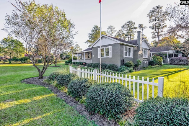 view of side of property with a yard