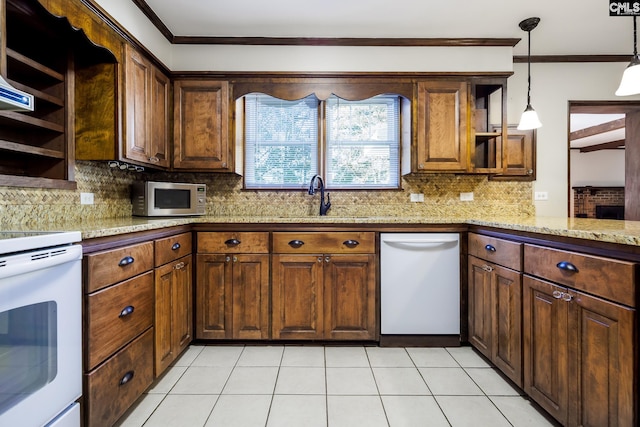 kitchen featuring kitchen peninsula, backsplash, white appliances, crown molding, and sink