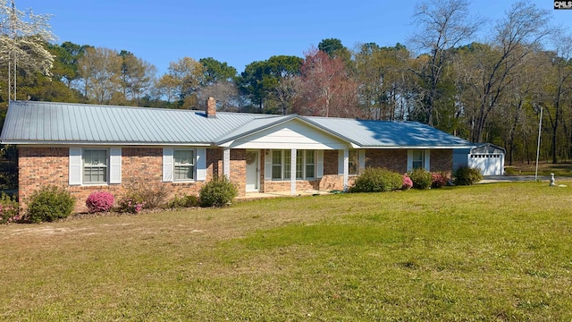 ranch-style house with an outbuilding, a front lawn, a porch, and a garage