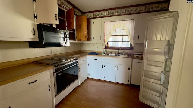 kitchen with white cabinets, white appliances, and sink