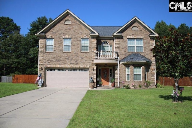 view of front facade with a garage, a balcony, and a front yard