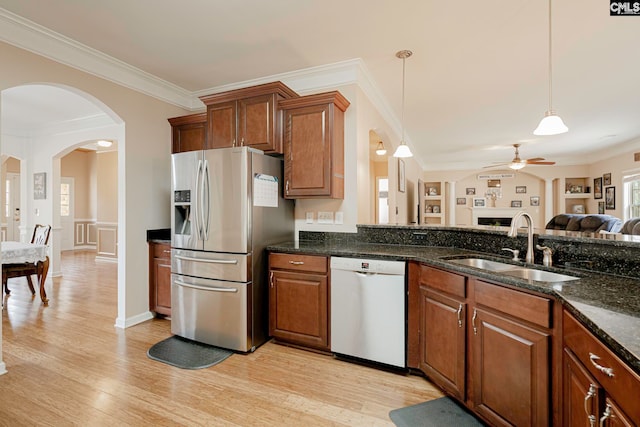 kitchen featuring pendant lighting, dishwasher, crown molding, light wood-type flooring, and stainless steel fridge with ice dispenser