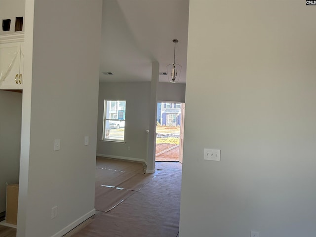 corridor with wood-type flooring