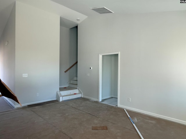 unfurnished room featuring concrete floors