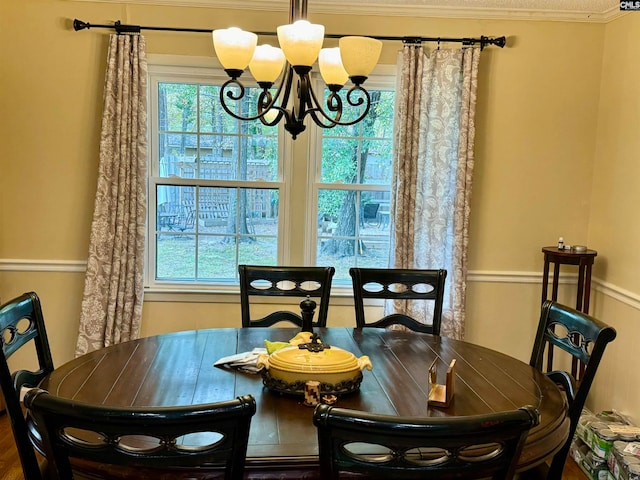 dining space featuring crown molding and a chandelier