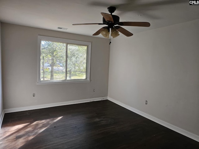 spare room featuring ceiling fan and dark hardwood / wood-style flooring