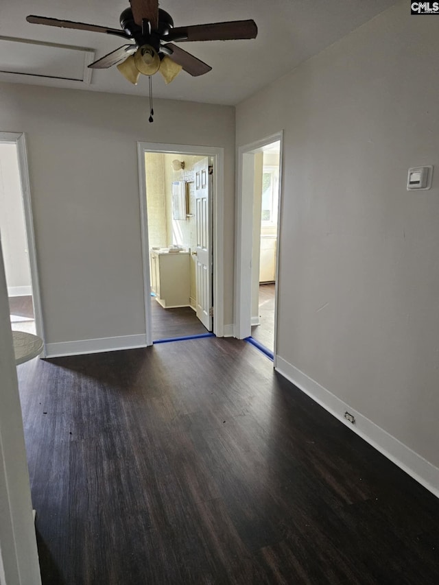 empty room with dark hardwood / wood-style flooring and ceiling fan