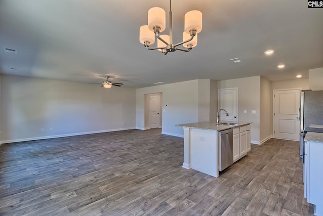 kitchen featuring white cabinetry, sink, decorative light fixtures, appliances with stainless steel finishes, and hardwood / wood-style flooring