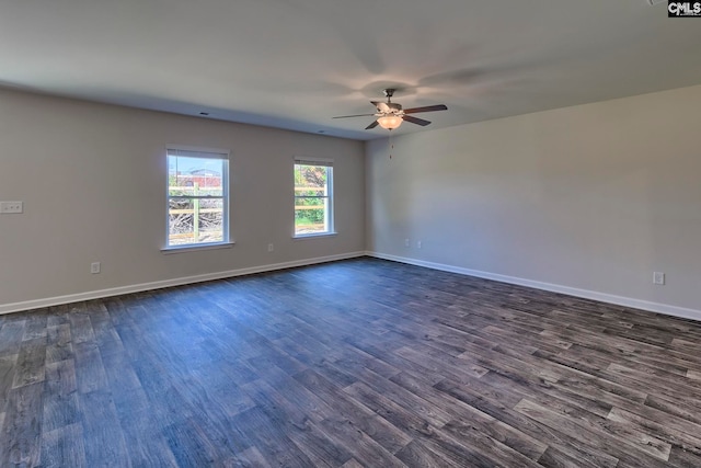 empty room with ceiling fan and dark hardwood / wood-style floors