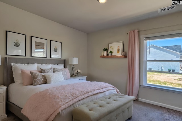 carpeted bedroom with multiple windows