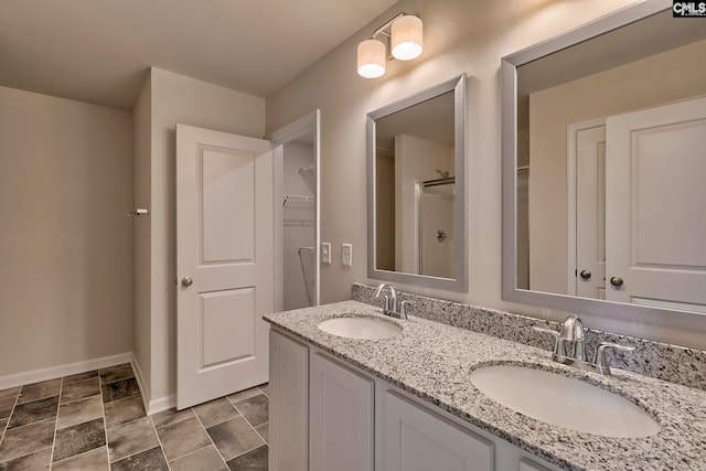 bathroom featuring vanity and an enclosed shower