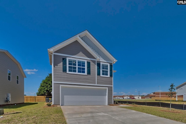 view of front of home with a front yard and a garage