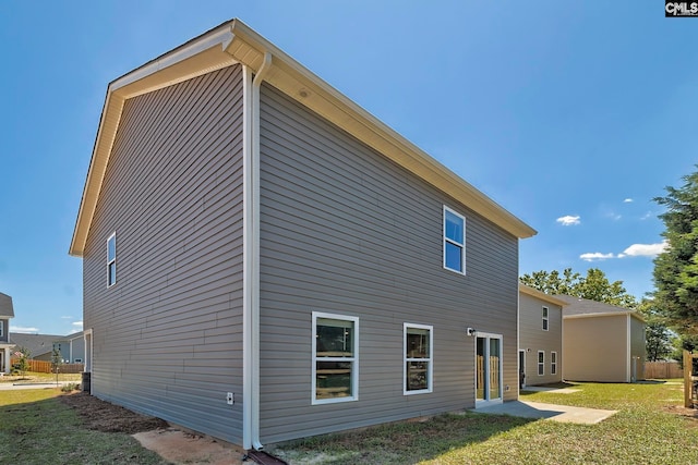 rear view of property featuring a yard