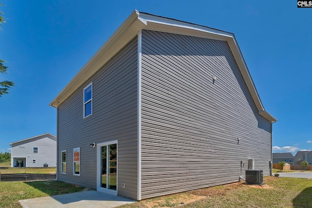 view of side of home with central air condition unit