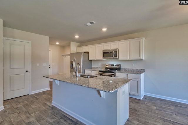 kitchen with white cabinets, light wood-type flooring, sink, and appliances with stainless steel finishes