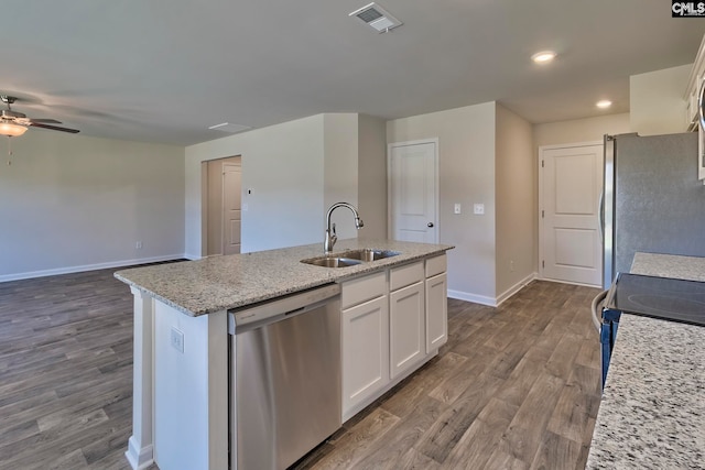 kitchen featuring white cabinets, sink, hardwood / wood-style flooring, an island with sink, and appliances with stainless steel finishes