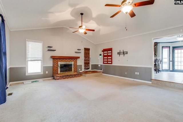 unfurnished living room with carpet flooring, plenty of natural light, and lofted ceiling