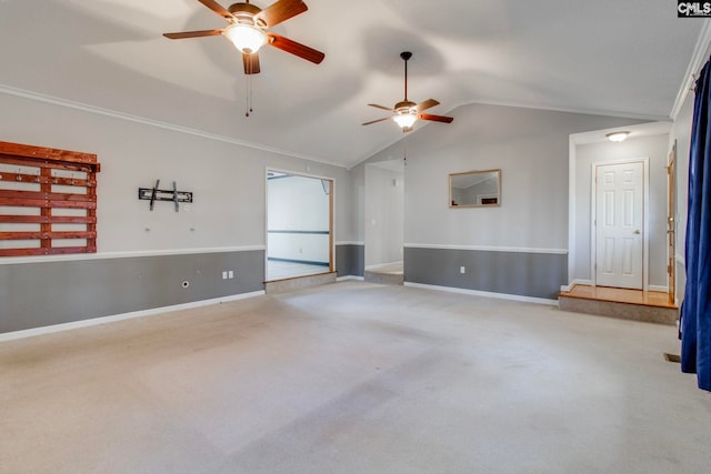 empty room with ceiling fan, light colored carpet, and vaulted ceiling