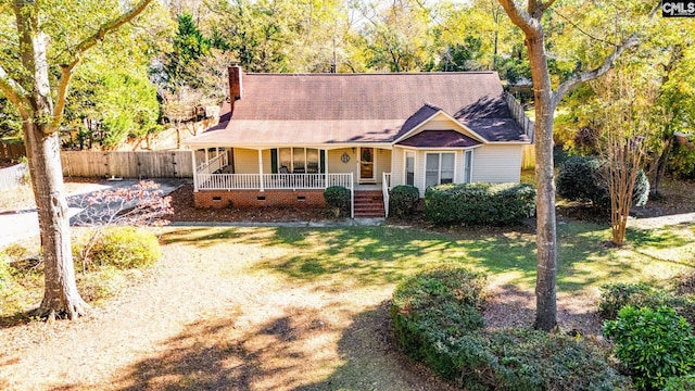 ranch-style home with a porch and a front yard