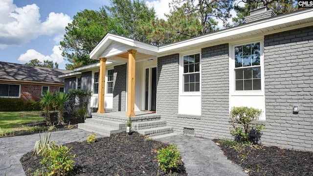 view of exterior entry with covered porch