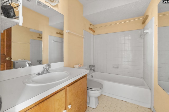 full bathroom featuring tiled shower / bath combo, toilet, a textured ceiling, and vanity