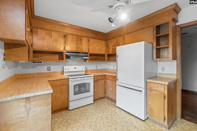 kitchen featuring ceiling fan, white appliances, and a textured ceiling