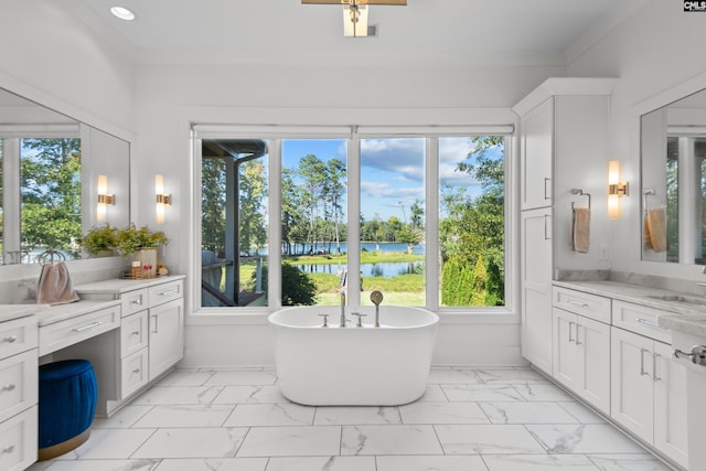 bathroom featuring vanity, a water view, ornamental molding, and a bath