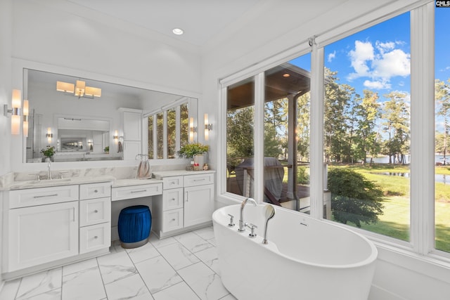 bathroom featuring a bathing tub, vanity, and ornamental molding