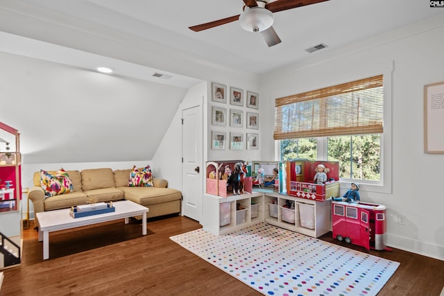 rec room featuring vaulted ceiling, ceiling fan, and dark wood-type flooring