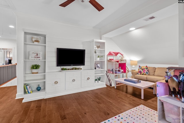 living room featuring ceiling fan, lofted ceiling, wood-type flooring, and built in shelves