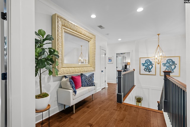 corridor featuring hardwood / wood-style flooring and a chandelier